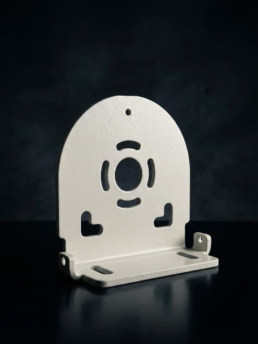 White powder-coated stamped steel cable bracket with motor mount cutout pattern
