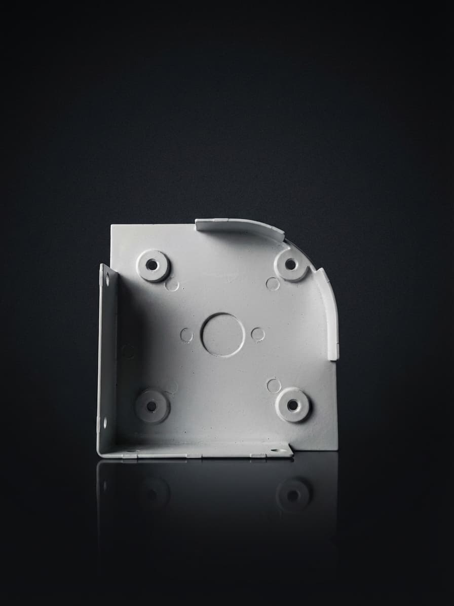 Aluminum endcap for motorized screen housing roller tube on dark studio background