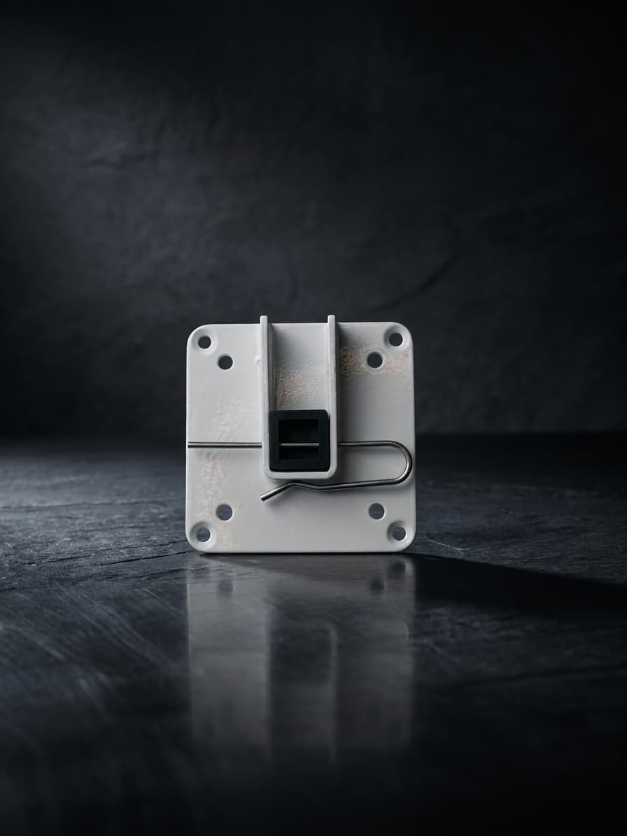 White powder-coated stamped idler mounting plate with center bore and pre-drilled hole pattern