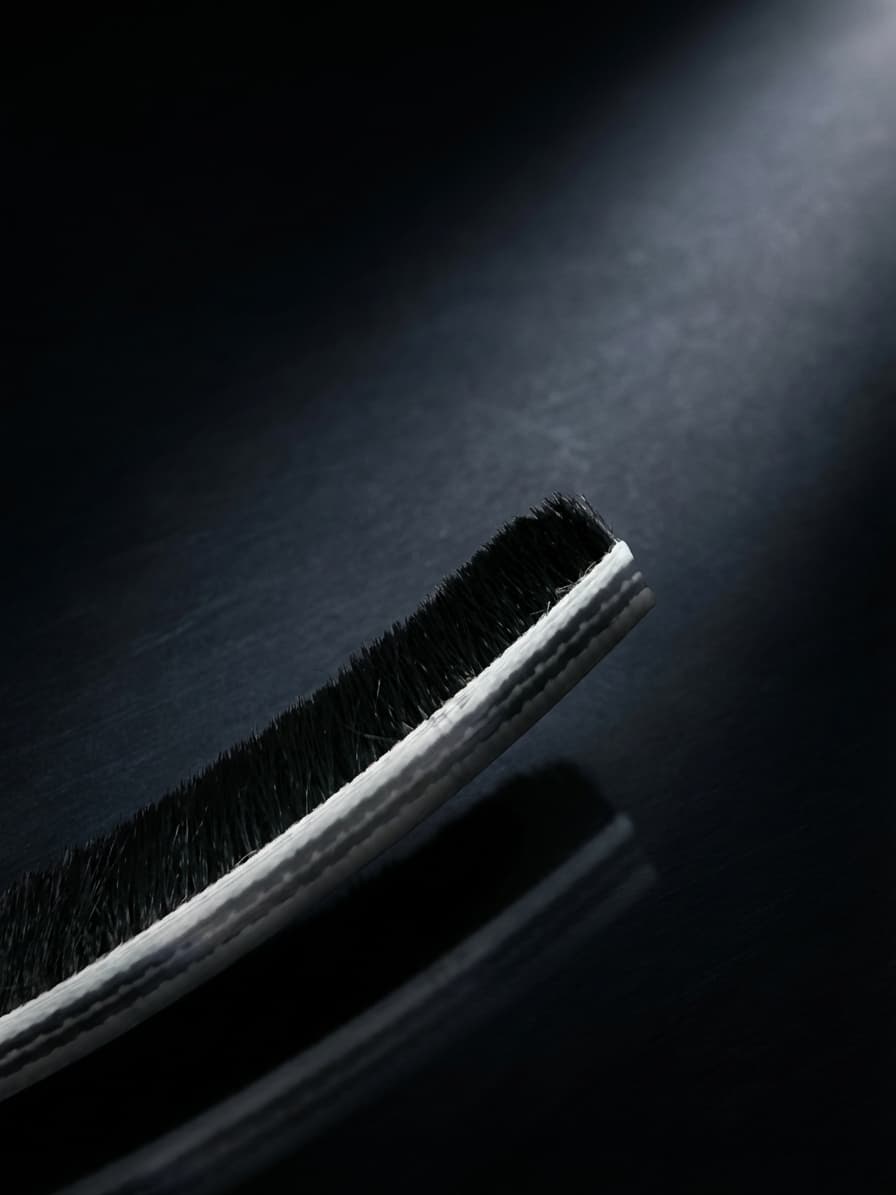 Pile weatherstrip brush seal with polypropylene bristles on woven backing strip