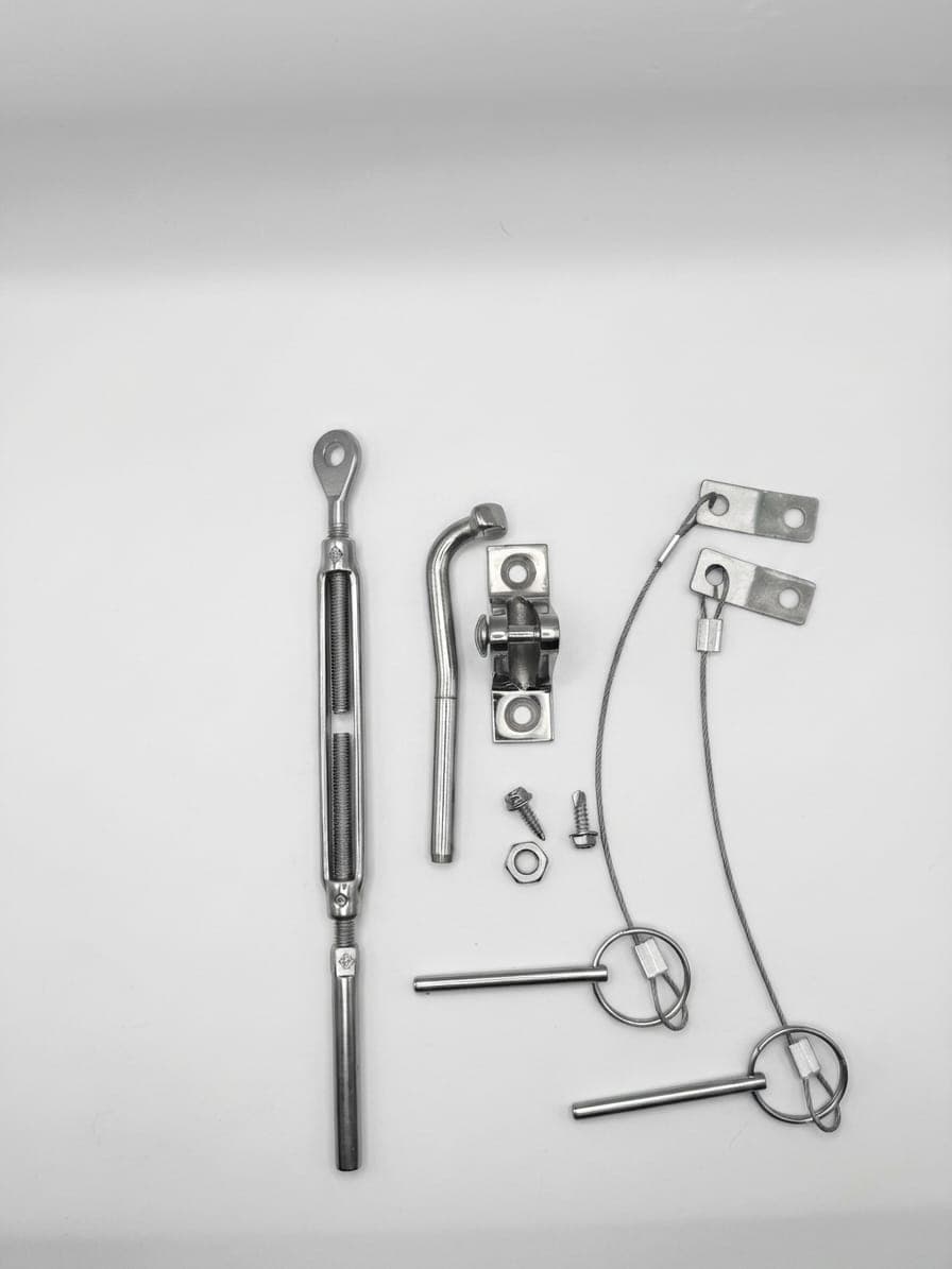 Motor locking safety kit: turnbuckle, hook, eye pad and lanyard pins laid out on white
